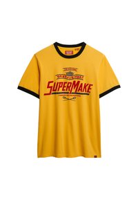 Yellow cotton t-shirt with black ringer neckline. Features large red "SuperMake" graphic and small logo on the left side near the hem.