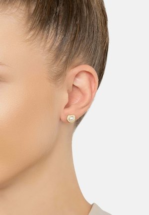 Gold-tone stud earrings featuring a central pearl surrounded by a decorative halo. Smooth texture with a polished finish.
