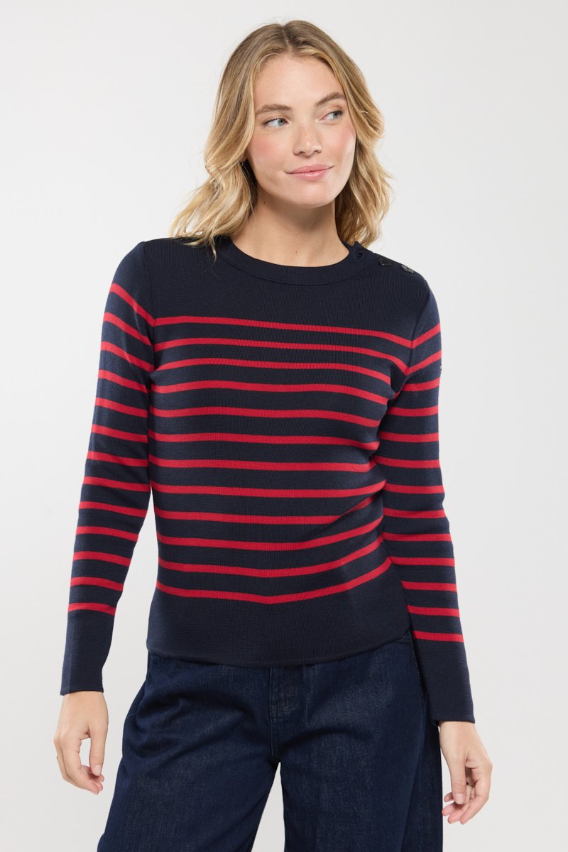 Marineblauwe trui met rode horizontale strepen, ronde halslijn, lange mouwen en schouderknopenaccenten. Zacht gebreid materiaal met een lichte rek.