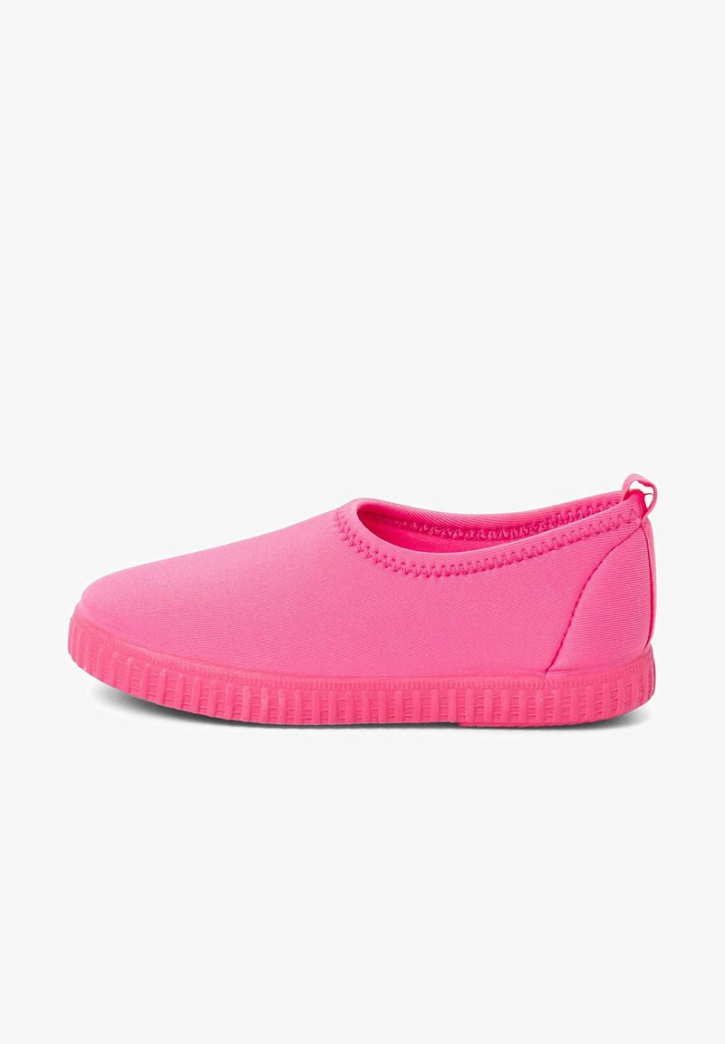 Pink slip-on shoe made of smooth, flexible material. Low-cut design, round toe, textured rubber sole, and stitching along the opening.
