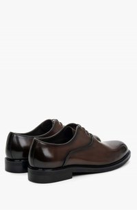 Brown leather dress shoes with a polished finish, rounded toe, lace-up design, and a black sole. Smooth texture with subtle detailing.