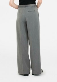 Grey wide-leg trousers with a smooth texture, featuring a waistband, a back pocket, and subtle seams, suitable for formal or casual wear.