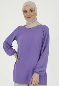 Purple long-sleeve top with gathered cuffs, made of lightweight fabric; features a round neckline and a relaxed fit.