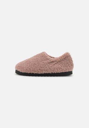 Pink fuzzy slipper with a textured, soft exterior and a black rubber sole. Low-cut design without any visible hardware or accents.