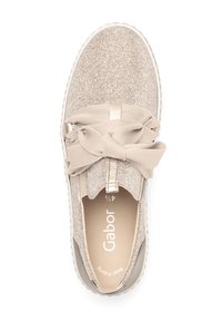 Beige sneaker with a textured, glittery upper and large fabric bow on the front. Features a cushioned insole and contrasting sole.