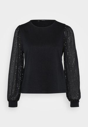 Black top featuring a smooth fabric body and long, sheer sleeves adorned with sequins for texture and shine. Round neckline and fitted cuffs.