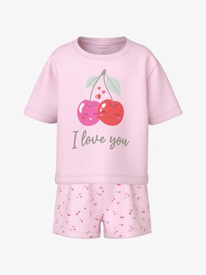 Rózsaszín rövid ujjú gyermekfelső mosolygó cseresznyékkel és "Szeretlek" felirattal, rózsaszín rövidnadrággal, amelyen apró cseresznye- és virágminták találhatók.