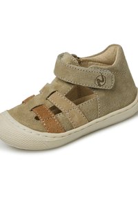 Beige semišové sandály s křížovými pásky, suchým zipem a gumovou podrážkou. Mají dvoubarevné akcenty ve světlejším a tmavším béžovém odstínu.