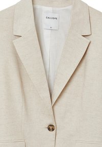 Beige linen blazer with notched lapels, single brown button closure, and visible "CALLIOPE" size S label inside collar.