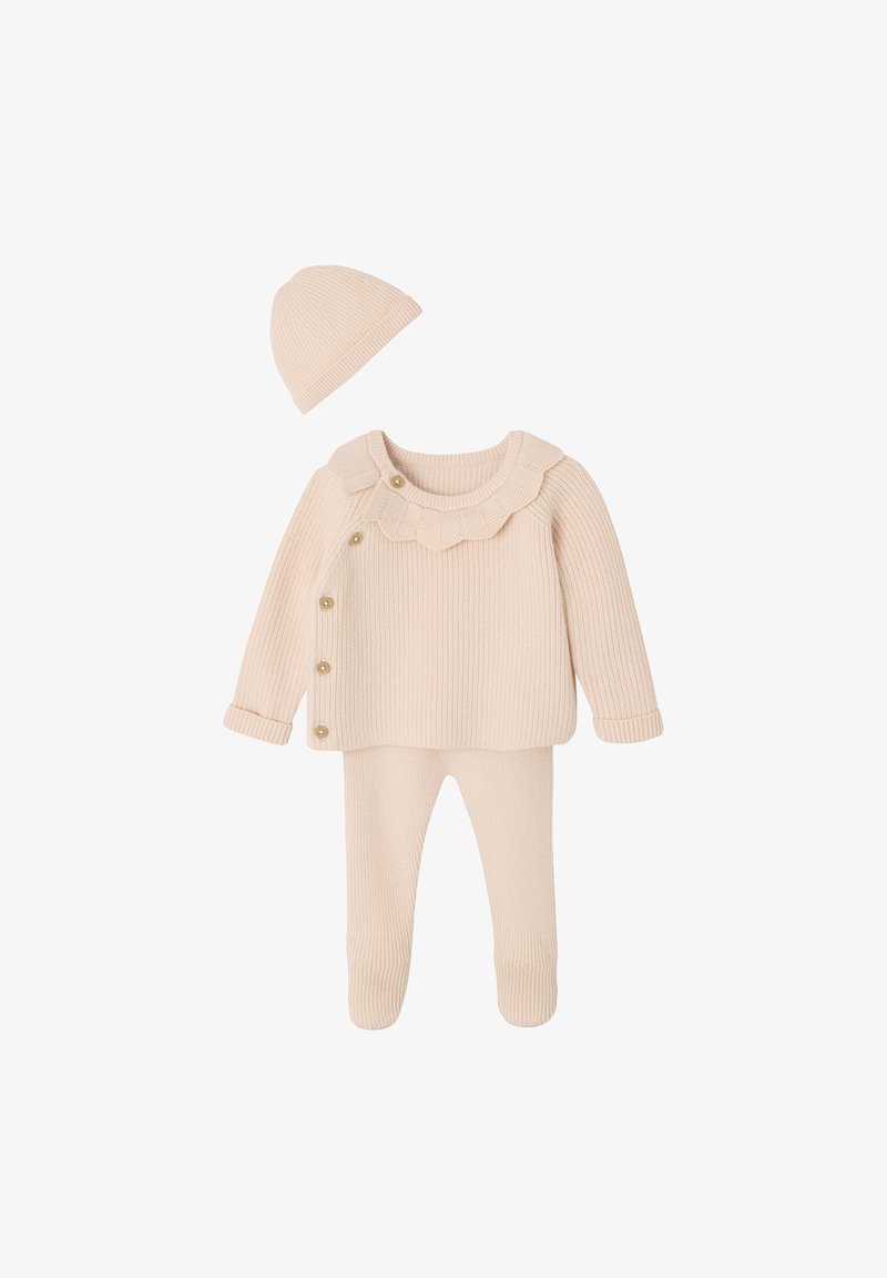 Cream-colored ribbed knit baby set with long-sleeve top featuring side buttons, matching footed pants, and a beanie hat.