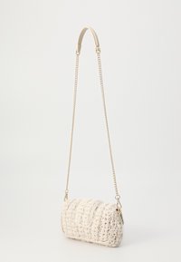 Crochet handbag in cream with a textured, quilted design. Features a metallic chain strap and a flap closure with subtle hardware detail.