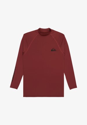 Dlhý rukáv košele v tmavočervenej farbe, vyrobený z hladkého syntetického materiálu. Má malý čierny logo na hrudi a čierny vzor textu na rukáve.