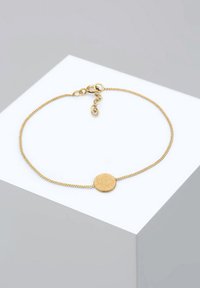 Guldarmband med en texturerad rund berlock, med en tunn kedja och en hummerlås för säker fastsättning.