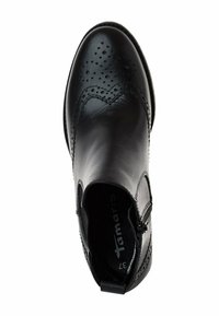 Bottine en cuir noir avec perforations brogues, fermeture éclair latérale et bout arrondi, vue de dessus sur fond blanc.