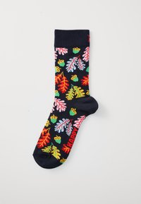 Chaussette marine avec un motif de feuilles d'automne colorées et de glands, et le texte rouge "HAPPY" près de l'orteil.