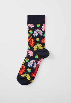 Navy sock with colorful autumn leaves and acorns pattern, and red "HAPPY" text near the toe.