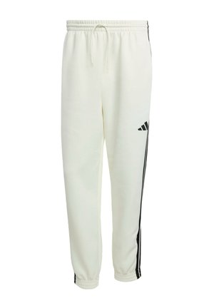Pantaloni da track bianco Adidas con strisce laterali nere, cintura elasticizzata con cordino e polsini elastici alle caviglie.