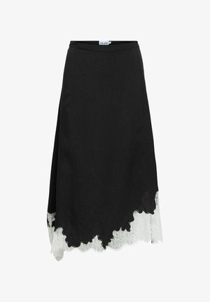 Svart midikjol med asymmetrisk fåll och vitt spetsdetalj som sträcker sig nedanför nederkanten.