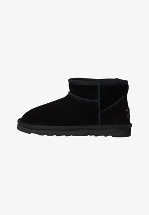 Black suede ankle boots with a low-profile design, rounded toe, and textured rubber sole. Features a stitched seam and subtle branding detail.
