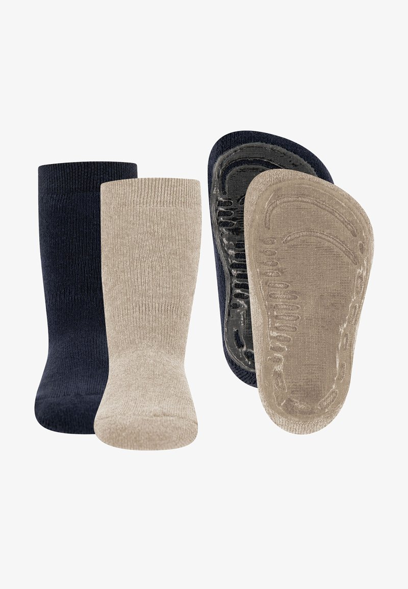 Zwei Paar Socken, ein marineblaues und ein beiges, beide mit rutschfesten Gummigreifen auf der Sohle, nebeneinander angeordnet.