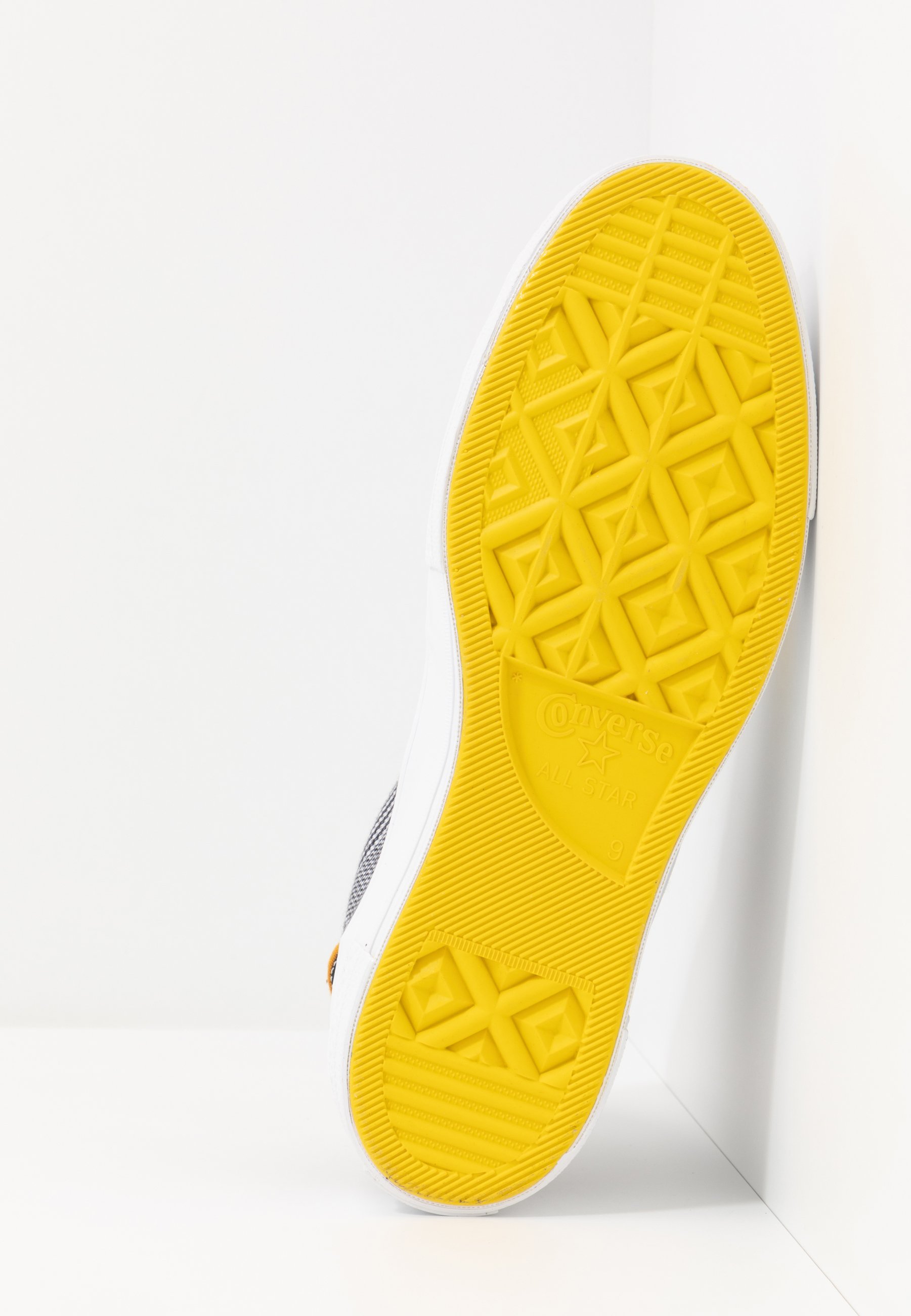 black and yellow chuck taylors