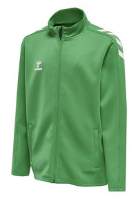 Giacca sportiva verde in morbido tessuto con chiusura a zip. Presenta un collo alto e accenti a zig zag bianchi sulle spalle. Due tasche laterali.