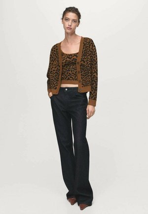 Brown leopard-print cardigan over a matching crop top, paired with dark flared jeans. The cardigan features buttons and a smooth texture.