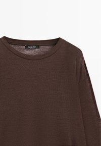 Brown knit sweater with a round neckline and dropped shoulders. Features a textured finish and a label displaying "Massimo Dutti."