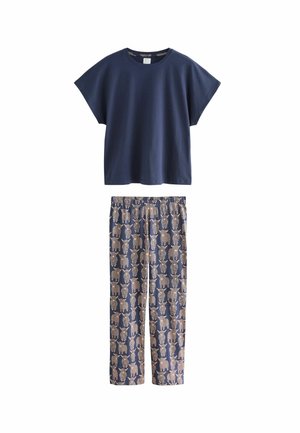 Navy cotton t-shirt with short sleeves paired with patterned pajama pants featuring elephant motifs in beige and gold on a dark background.