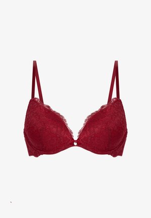 Soutien-gorge en dentelle rouge avec bonnets rembourrés, bretelles réglables et un petit nœud au centre. Motif floral mettant en valeur le design.