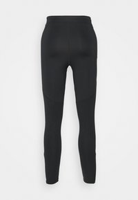 Leggings sportivi neri con design aderente. Le caratteristiche includono una vita alta e pannelli perforati per la ventilazione. Tessuto liscio e elastico.