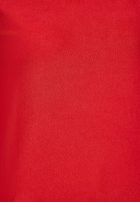 Roter Stoff mit einer glatten, strukturierten Oberfläche. Das Material scheint leicht und hat ein einheitliches Webmuster.