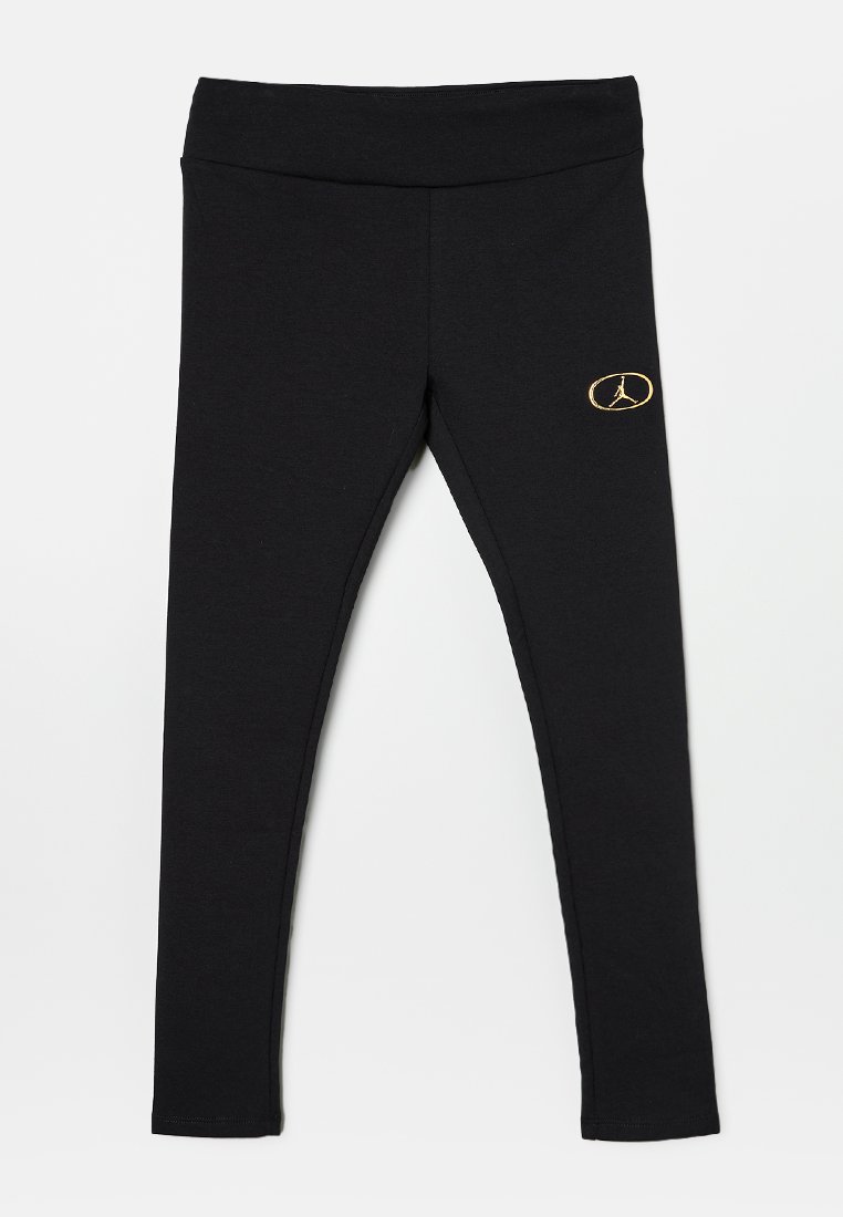 Schwarze Leggings aus weichem, dehnbarem Stoff. Mit einem breiten Bund und einem goldenen Logo-Akzent am unteren linken Bein. Figurbetontes Design.