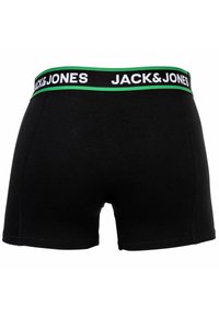 Svarta boxershorts i mjukt tyg, med ett brett elastiskt midjeband med grön och svart märkning. Enkla, åtsittande i design.