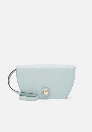 Light blue leather handbag with a half-moon shape, featuring a decorative round gold button and a thin strap. Smooth texture, minimal design.