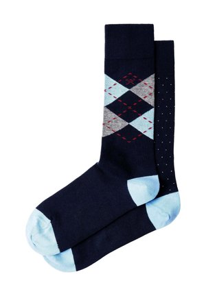 Paire de chaussettes bleu marine avec talons et orteils bleu clair, une chaussette présente un motif losange et l'autre de petits pois blancs.