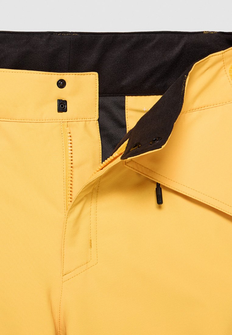 Gelbe Hosen aus strukturiertem Stoff, mit einem schwarzen Bund, Reißverschluss und zwei Knopfverschlüssen für sicheren Halt.
