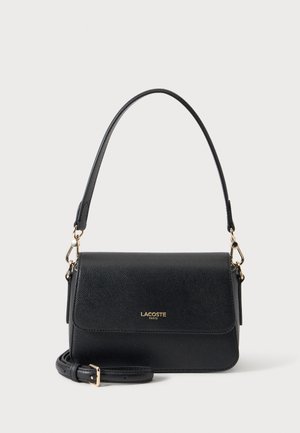 Sac à bandoulière en cuir noir texturé avec ferrures dorées, poignée supérieure, bandoulière réglable et logo "Lacoste Paris" sur le rabat avant.