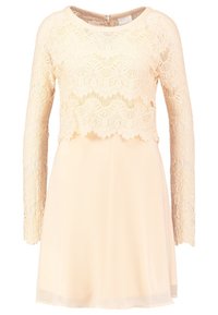 Cream-colored dress with long lace sleeves and a lace overlay bodice, featuring a round neckline and a short flowing skirt.