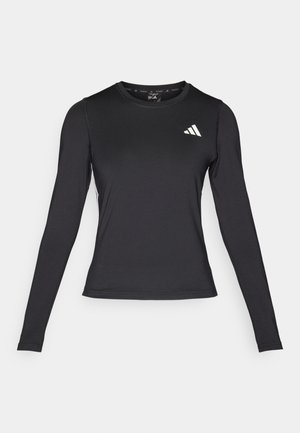 Svart langermet treningsskjorte laget av glatt, elastisk materiale. Har en hvit logo på brystet. Tettsittende design med rund hals.