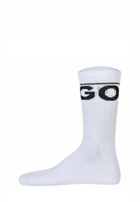 Calzino bianco in cotone con texture a coste e logo "GO" nero nella parte superiore. Il design è al ginocchio con una chiusura della punta liscia.