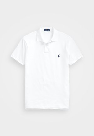 White polo shirt, short sleeves, collared neck, made of cotton, features a small navy logo on the left chest, classic design and fit.
