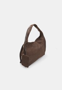 Brown suede handbag with a single shoulder strap, curved body, top zip closure, and an additional small zip pocket on the side.