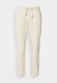 Beżowe, lekkie spodnie z elastycznym paskiem i sznurkiem. Posiadają zwężany krój nogawek oraz dwie boczne kieszenie. Wykonane z mieszanki bawełny.