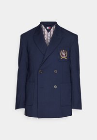 Navy kaksirivinen bleiseri villasekoitteesta, jossa on läpällinen tasku brodeeratulla logolla, kaksi etupainiketta ja kuviollinen vuori.