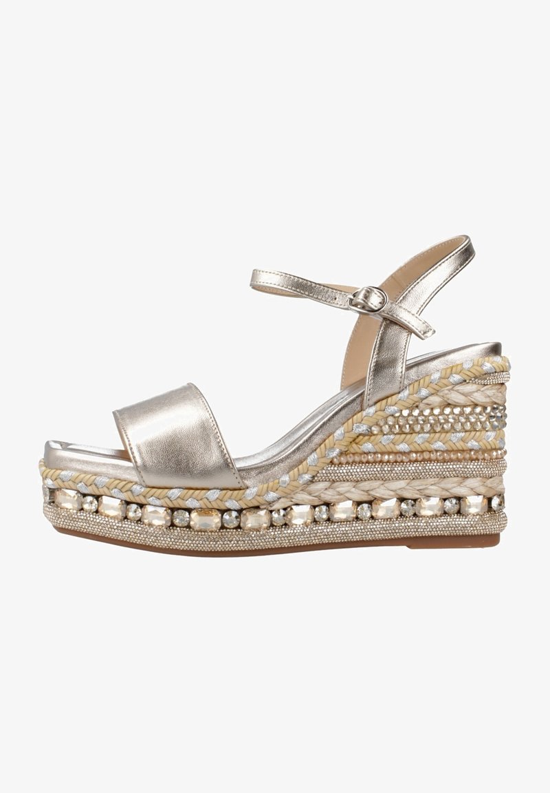 Sandalo wedge dorato metallico con tomaia in pelle liscia, paglia intrecciata e perline decorative sul tacco. Presenta una cinghia con fibbia.