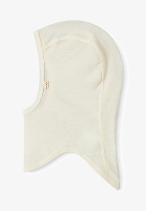 Light beige cotton balaclava with ribbed texture, rounded shape, and soft edges. Features a small brand tag on the side.