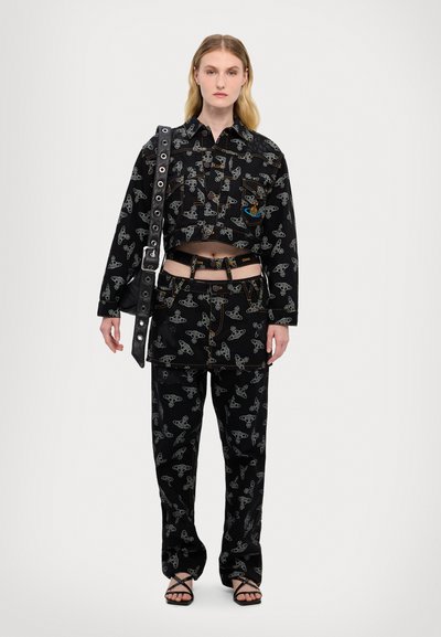 Black cropped jacket and patterned pants feature a design of light-colored motifs. Includes a black belt and a studded shoulder bag.