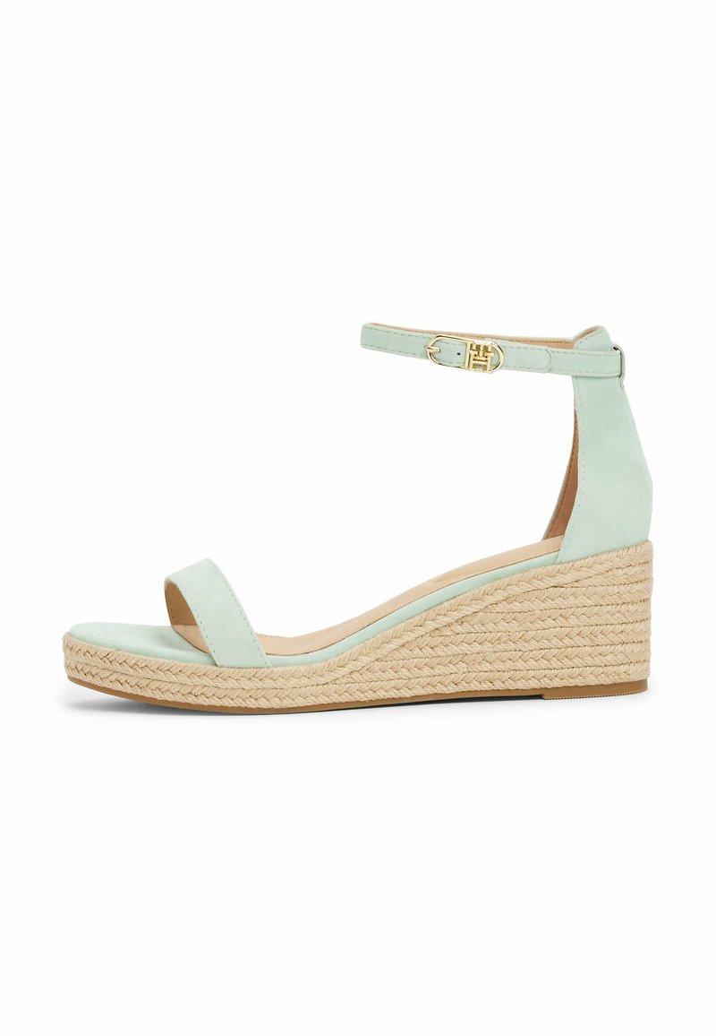 Sandalette con tacco a cuneo in suede verde menta, con una larga fascia anteriore, cinturino alla caviglia con fibbia dorata e piattaforma rivestita in juta intrecciata.