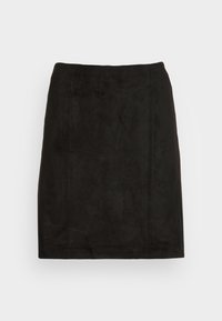 Musta tekonahasta valmistettu hame, jossa on tiukka siluetti, esiin tulevat saumat ja sileä, matta pinta. Minimalistinen muotoilu ilman koristeita.